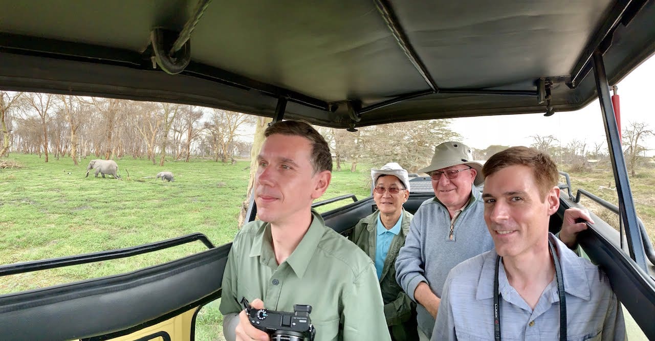 A closeup of travellers in a safari jeep.